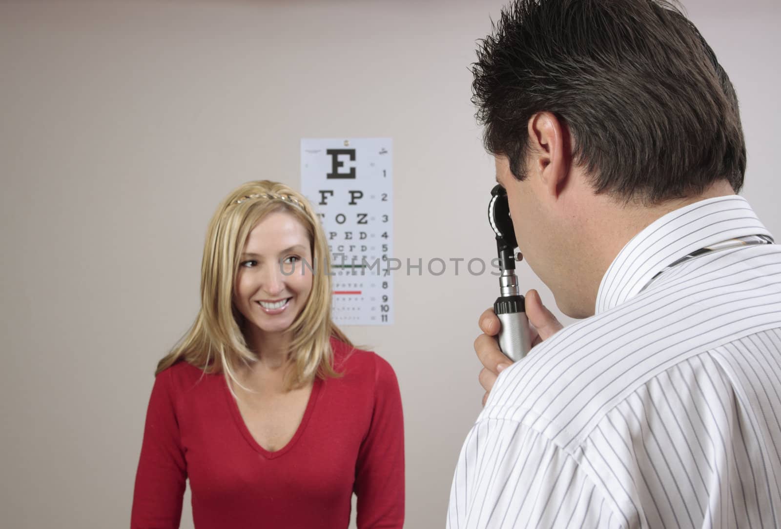 A female patient having her eyes checked by an eye doctor.