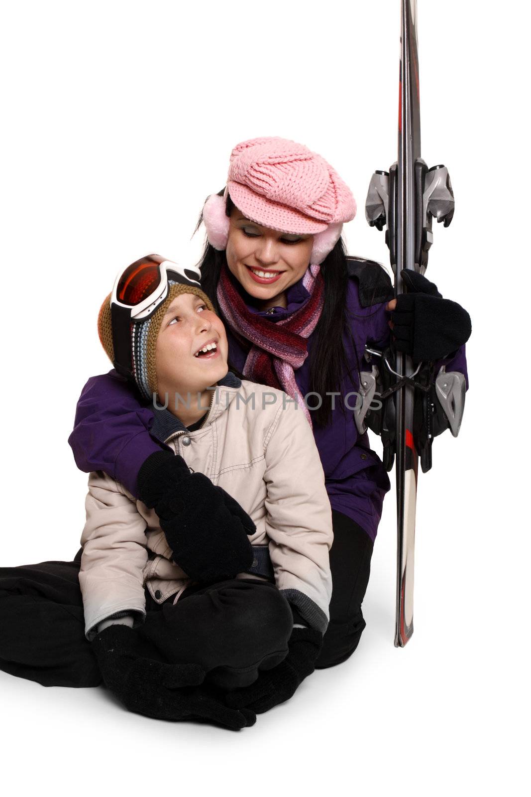 Loving family sitting together with their ski gear