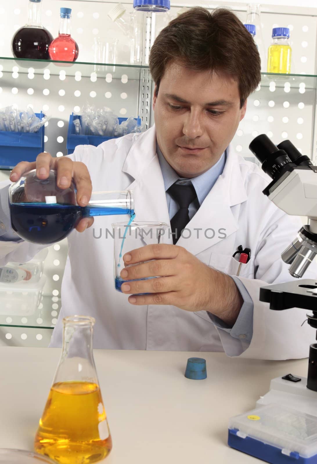 A scientist measuring liquids in a laboratory.