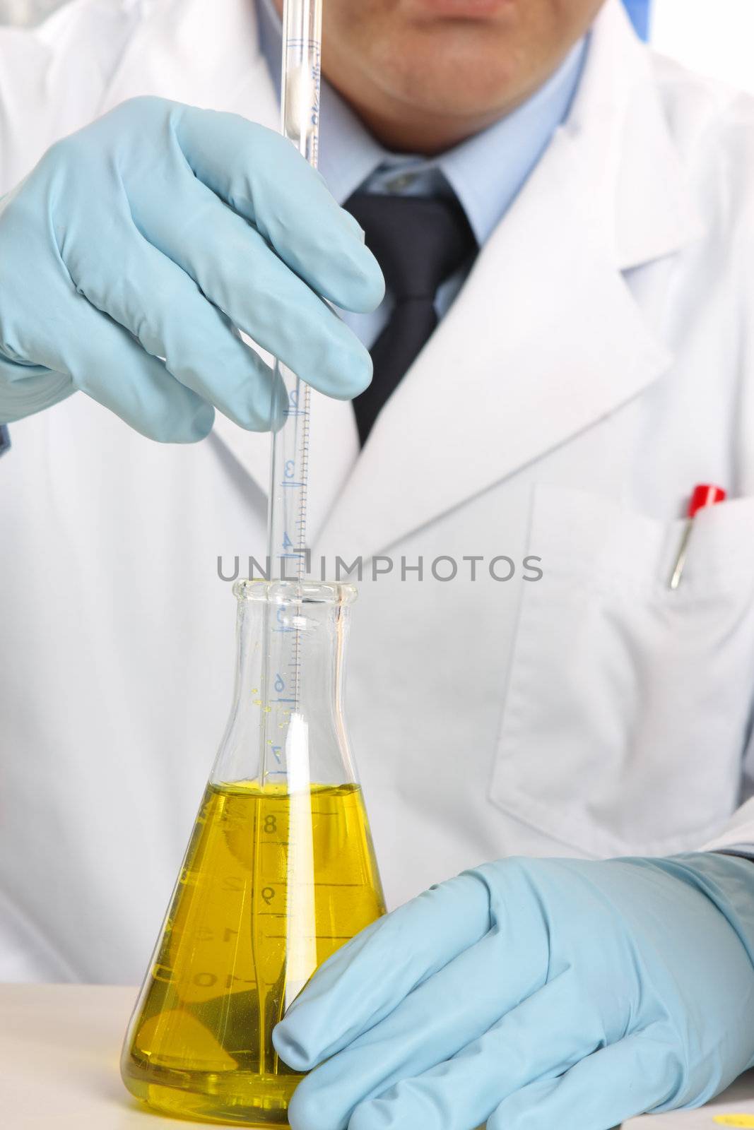 Scientist stirring liquid in flask by lovleah