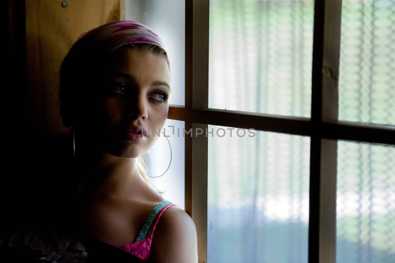 Silhouette of the girl in window