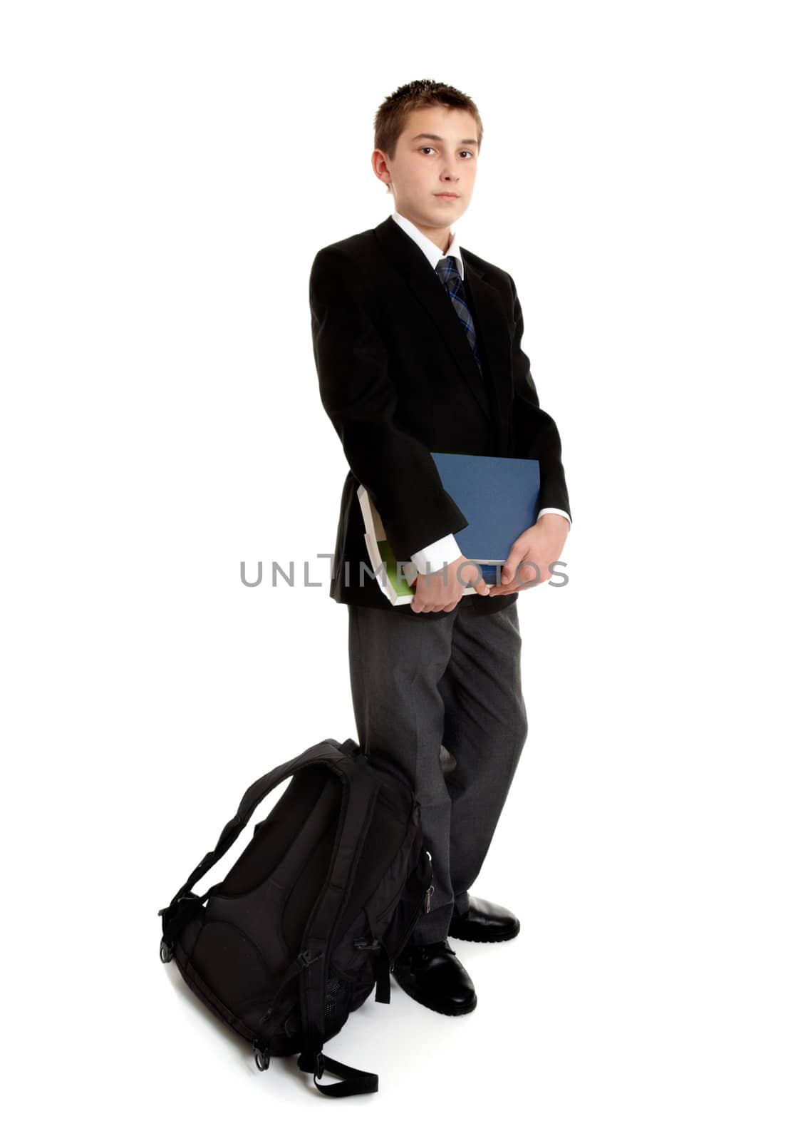 Standing school student with school bag and text books.