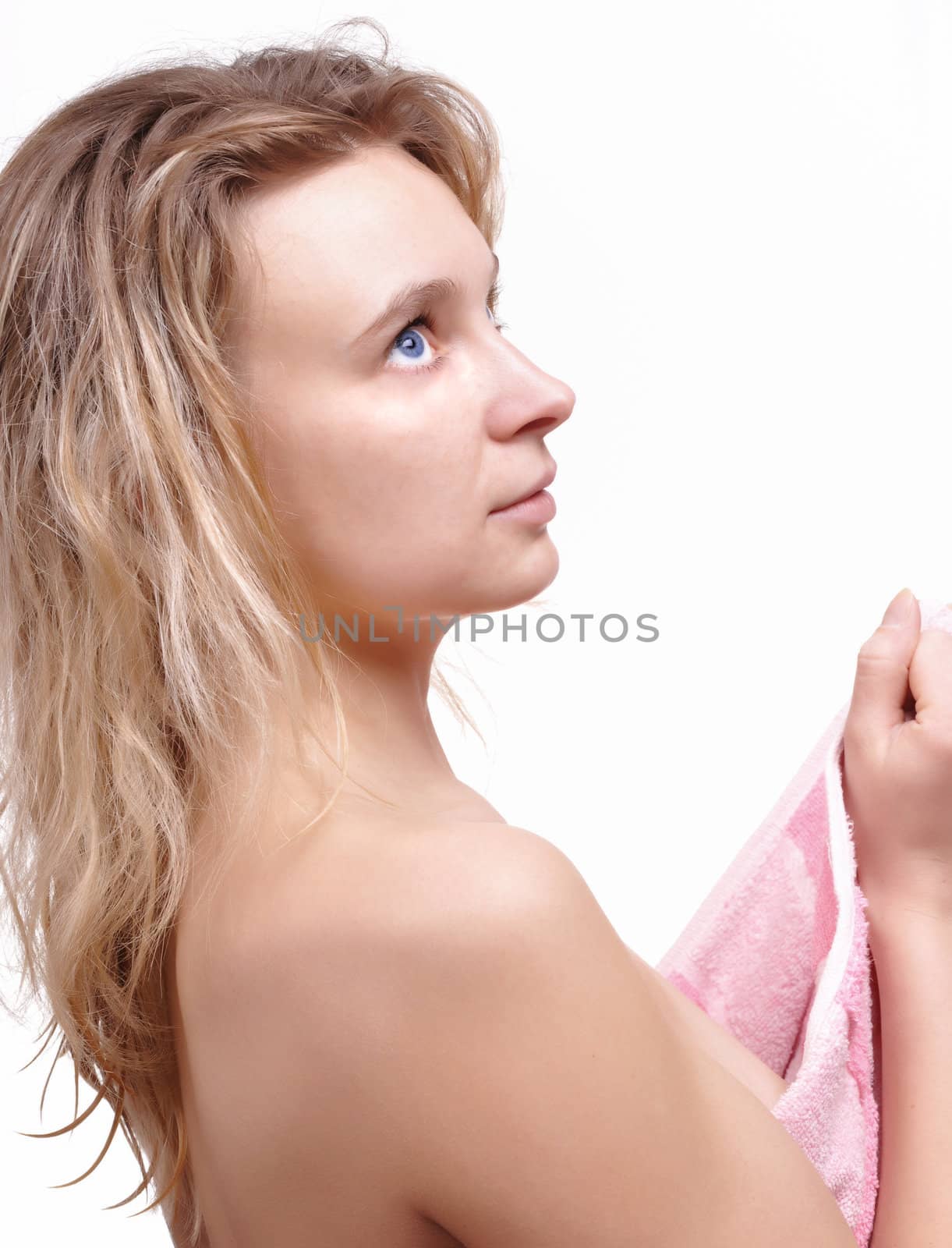 portrait of cheerful young adult girl looking up with towel