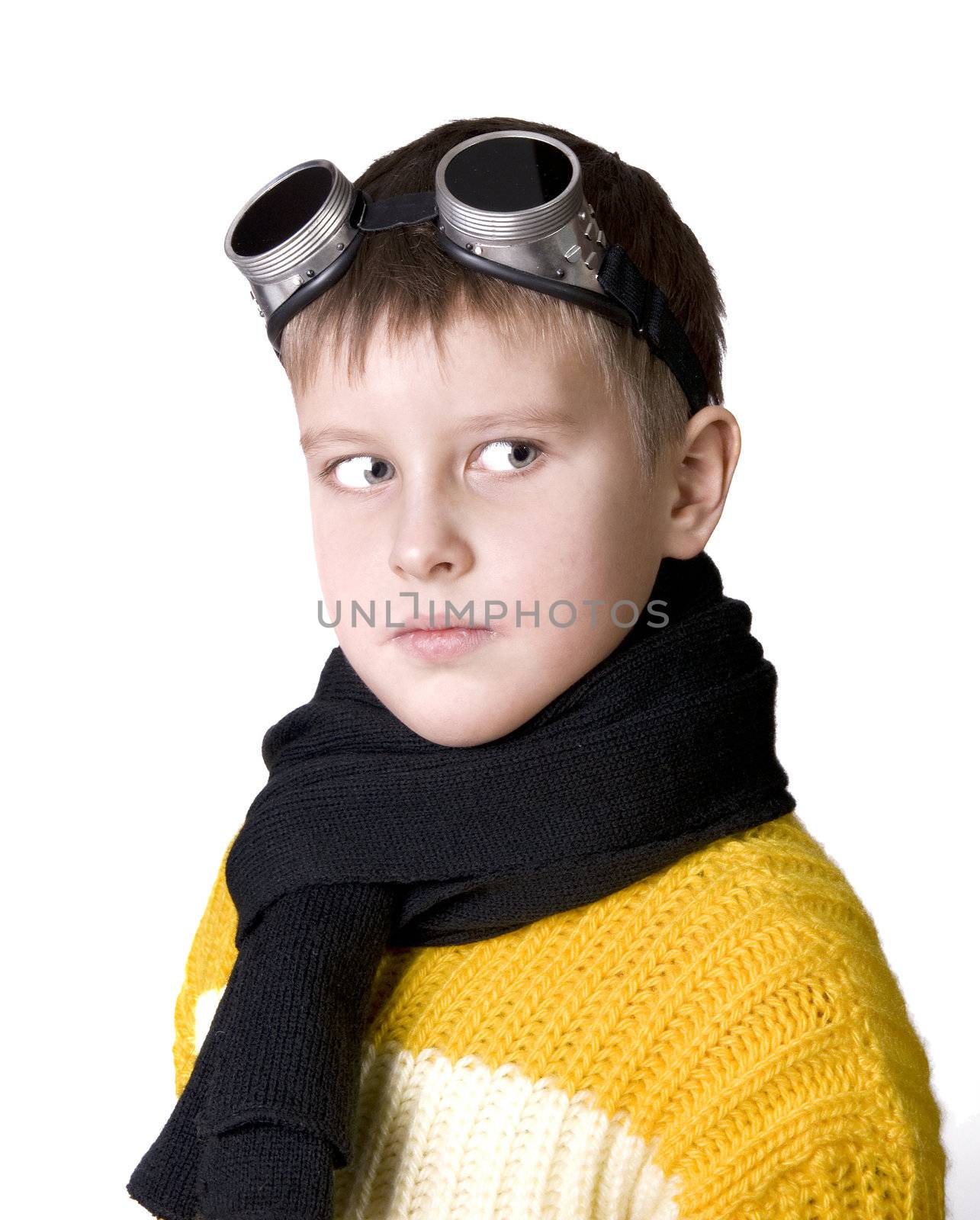 Small boy in dark glasses pretends to be a pilot looking in the camera 