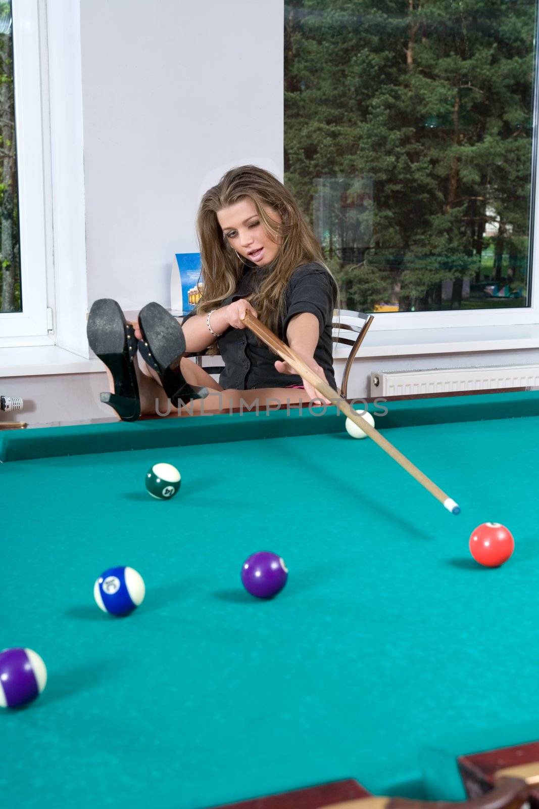 Young girl in short skirt playing snooker