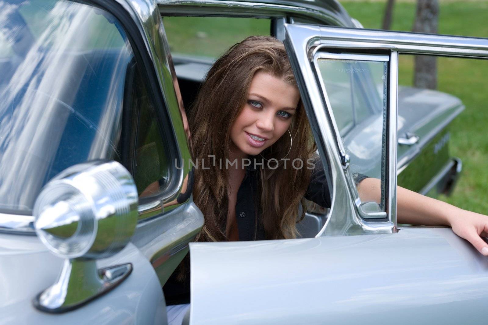 Young girl in short skirt in old-fashioned car