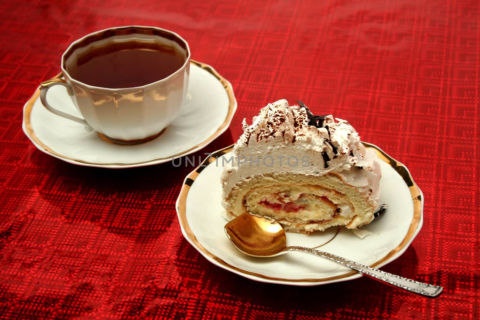 Cup of tea with the spoon and a slice of pie on red background, (look similar images in my portfolio)