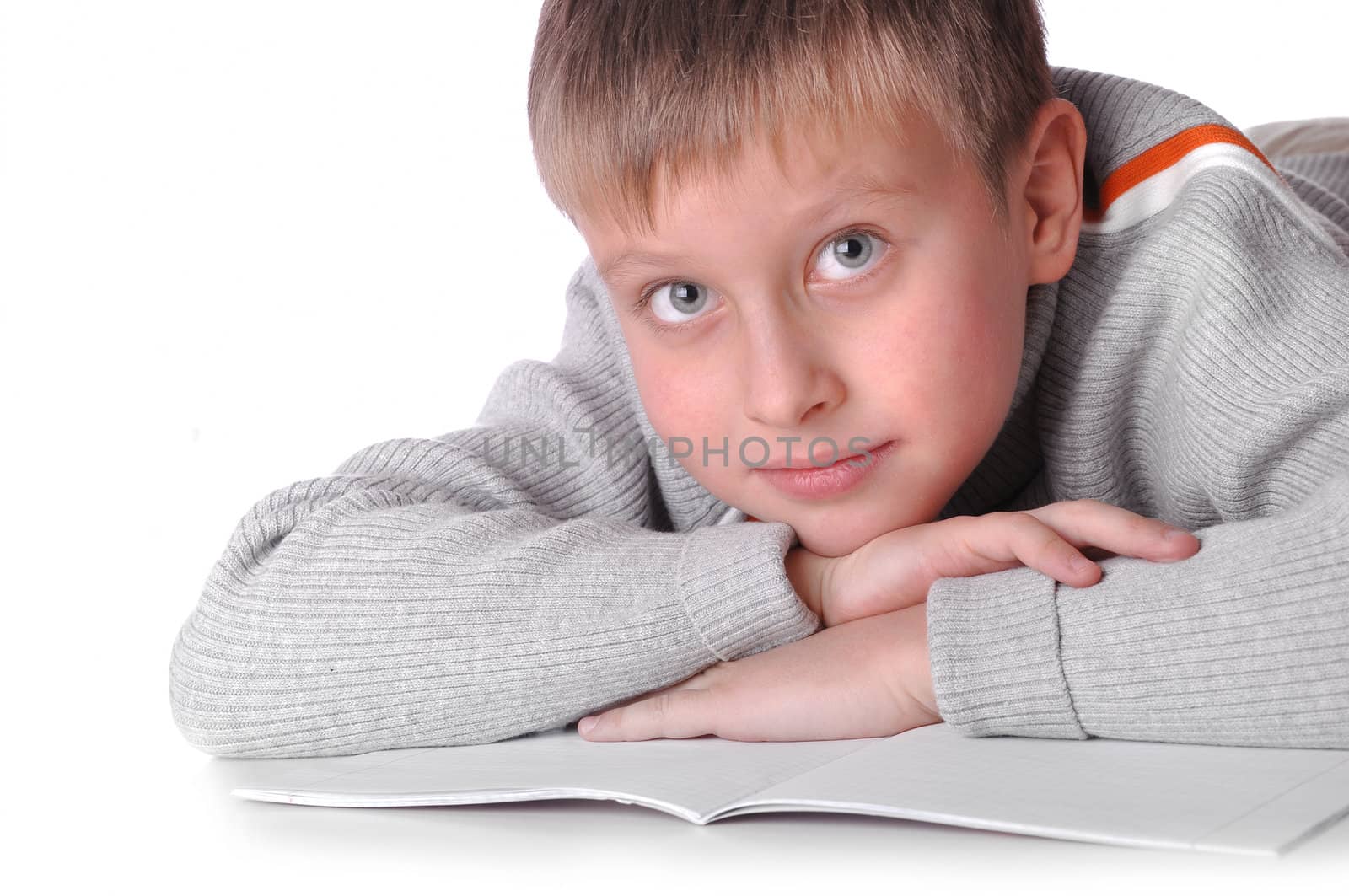 Young boy laying on the floor isolated over a white background