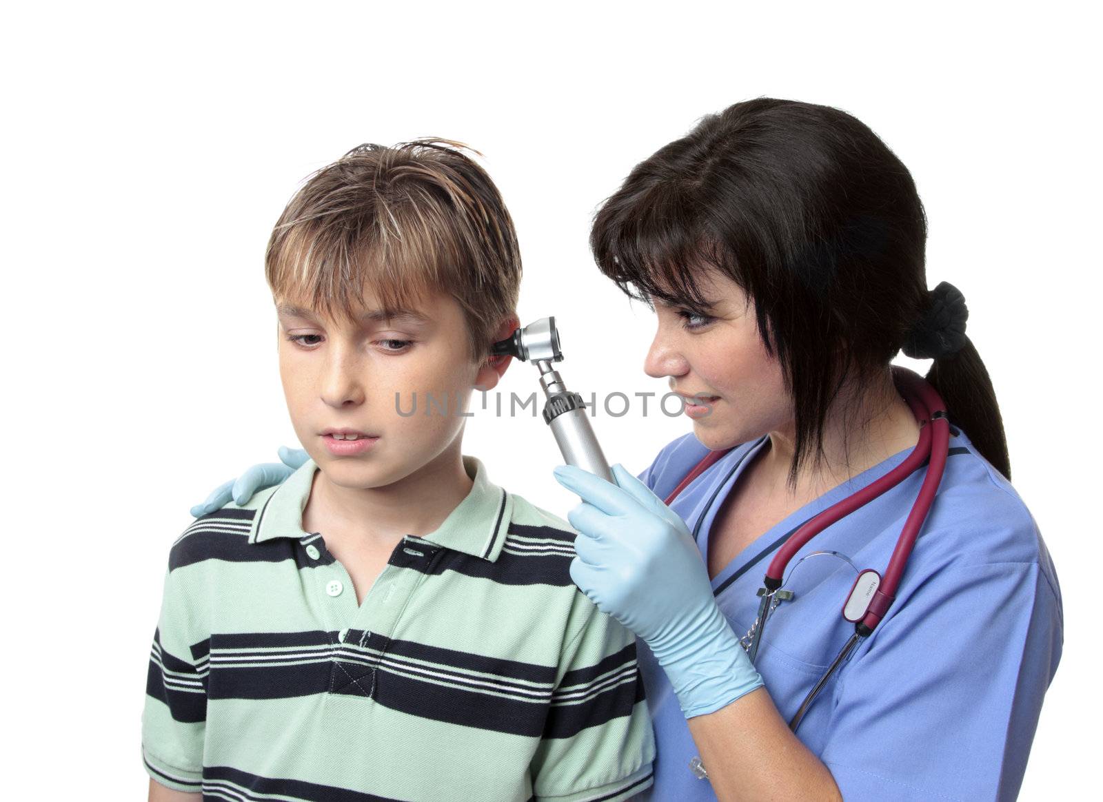 A female  doctor or nurse,  looks inside the ears of a boy.