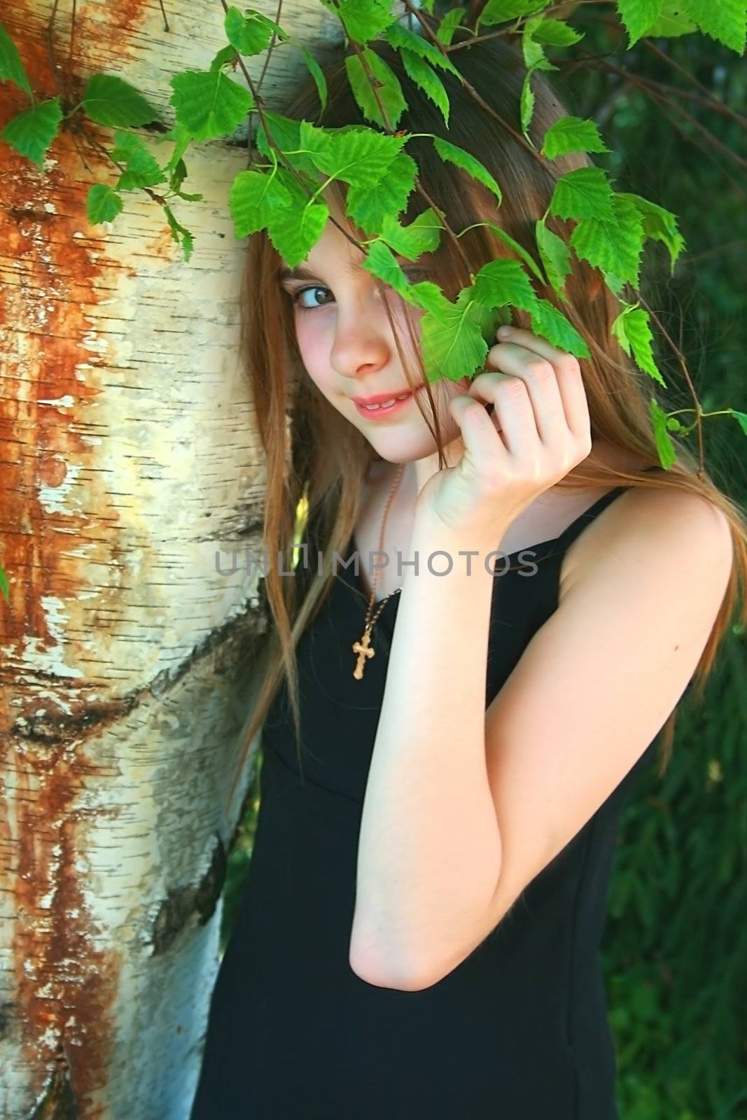 teen in nature with liitle crusafix