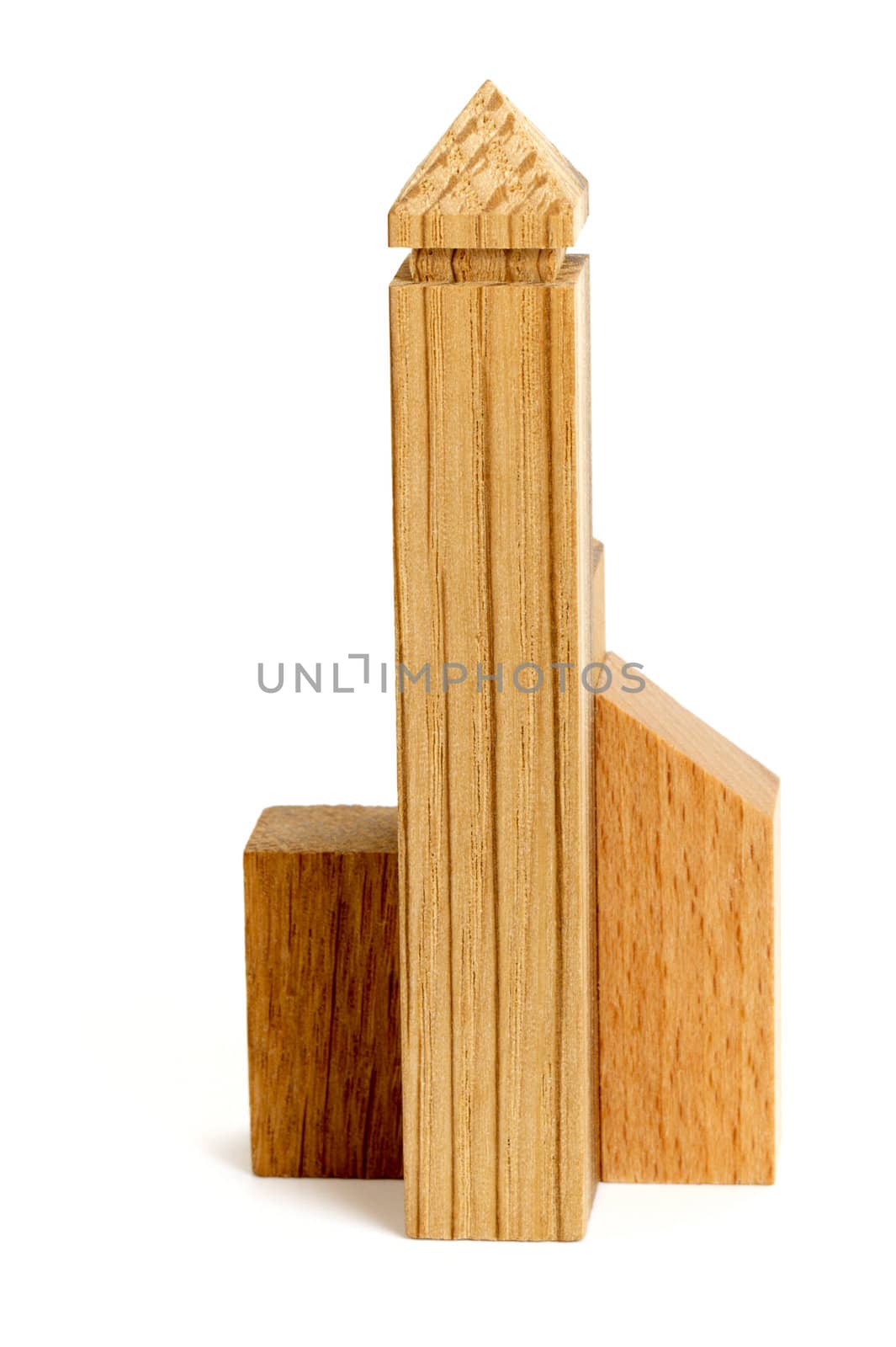 Detail of wooden puzzle in the form of buildings on white background. Macro.