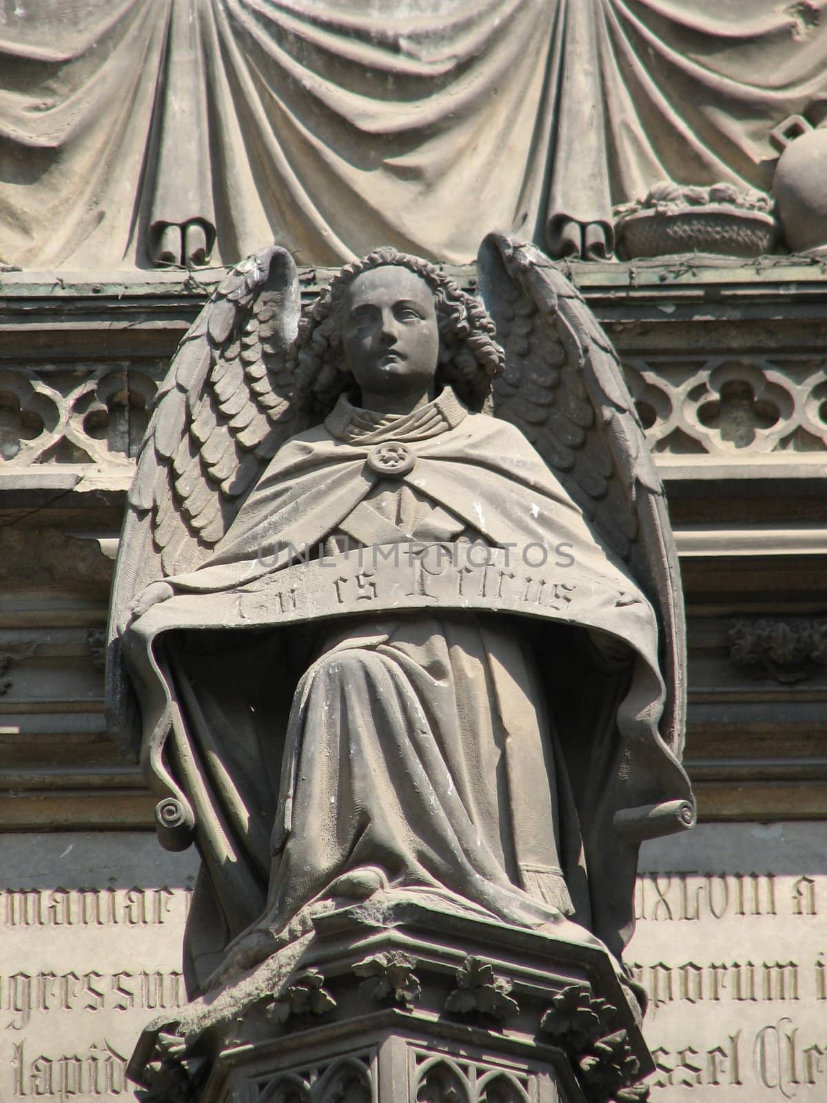 Stone angel at the main door portal of the cathedral at Cologne, Germany