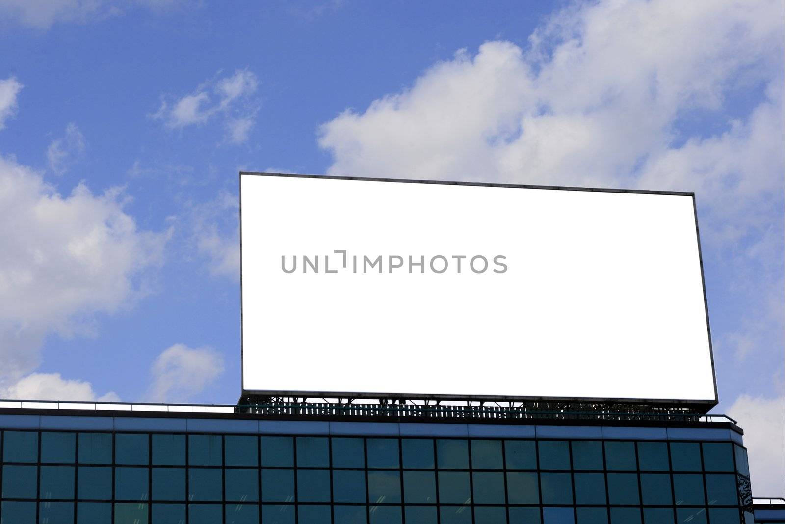 Blank Billboard  on top of a building in a blue sky background