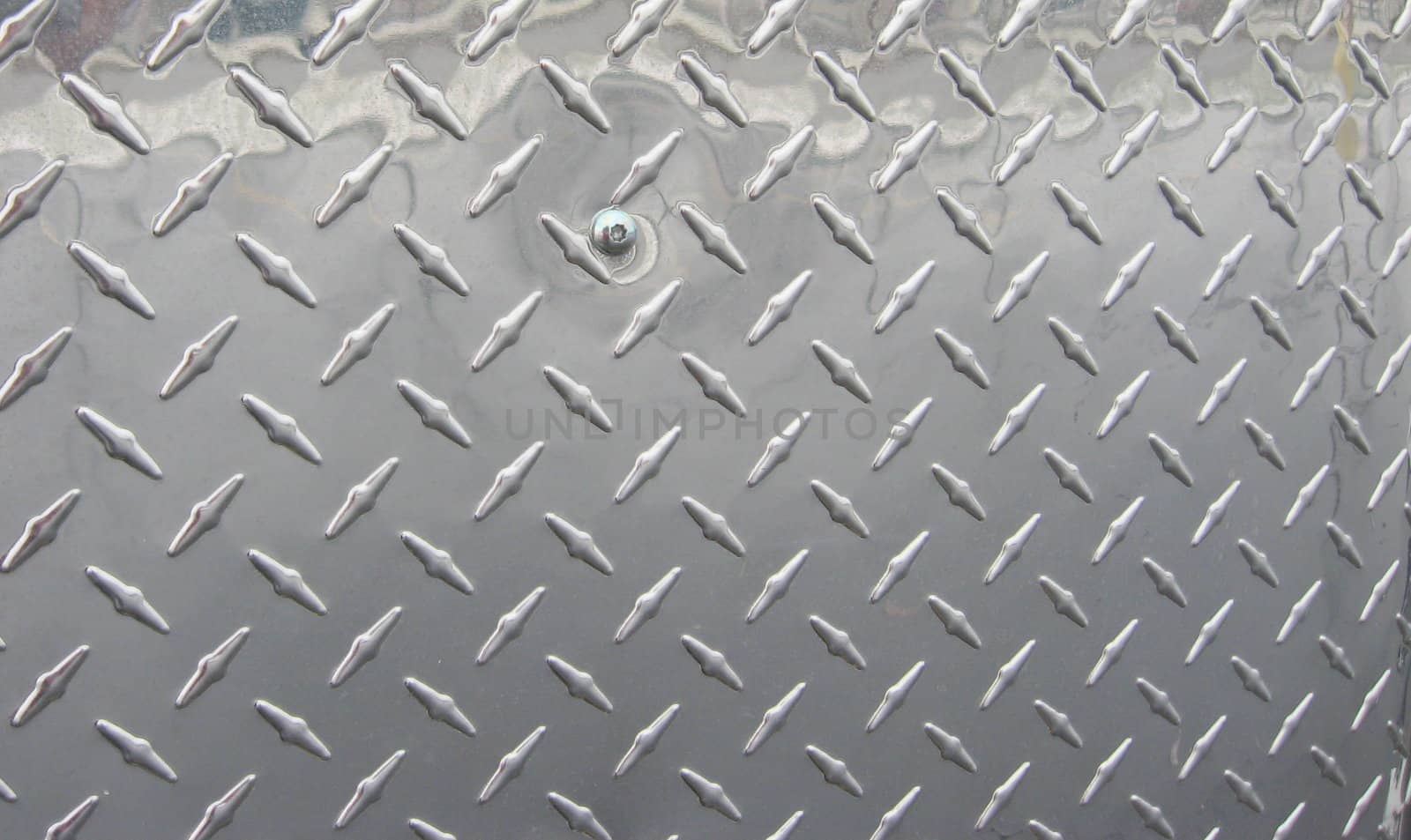 silver-colored diamond plate steel, useful for background, pattern, design