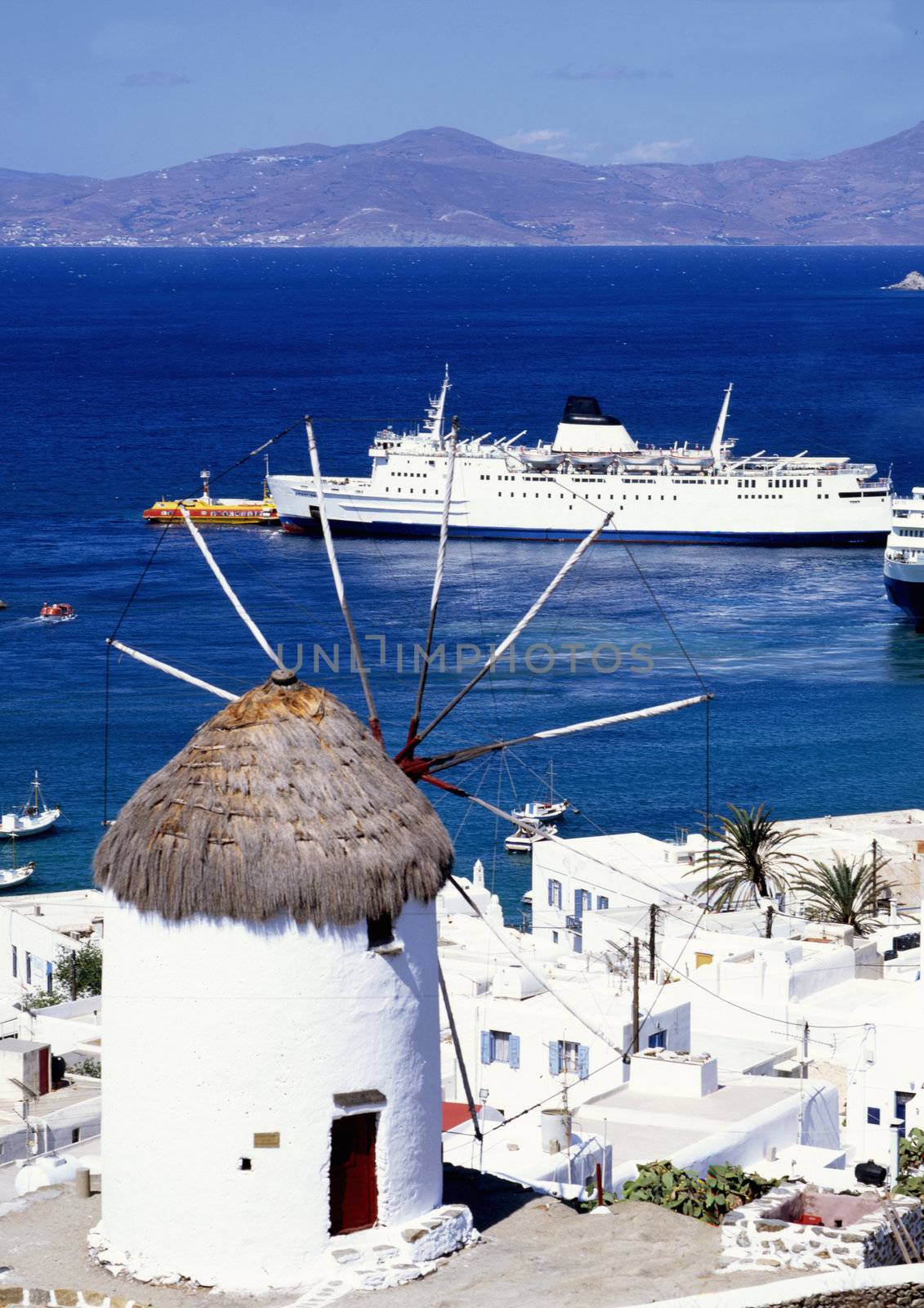 A windmill overlooking the harbour of Mykonos a greek island