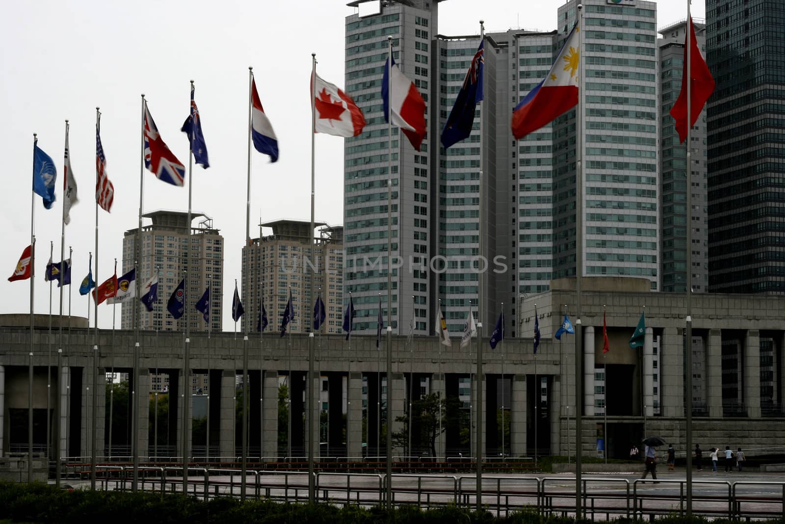 Flags of many countries waving in front of war memorial in Korea
