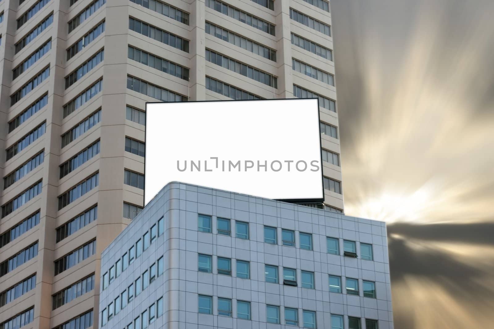 Blank Billboard on Top of Building with dramatic dusk background