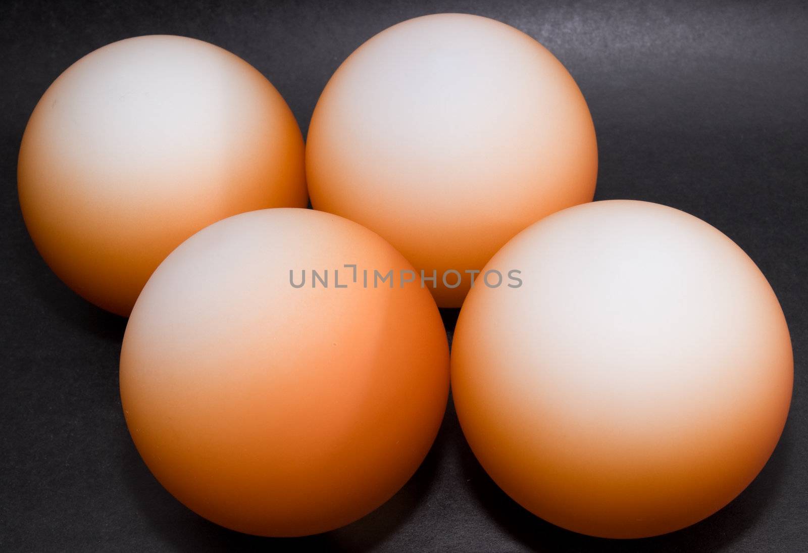 Orange balls on black background by andyphoto
