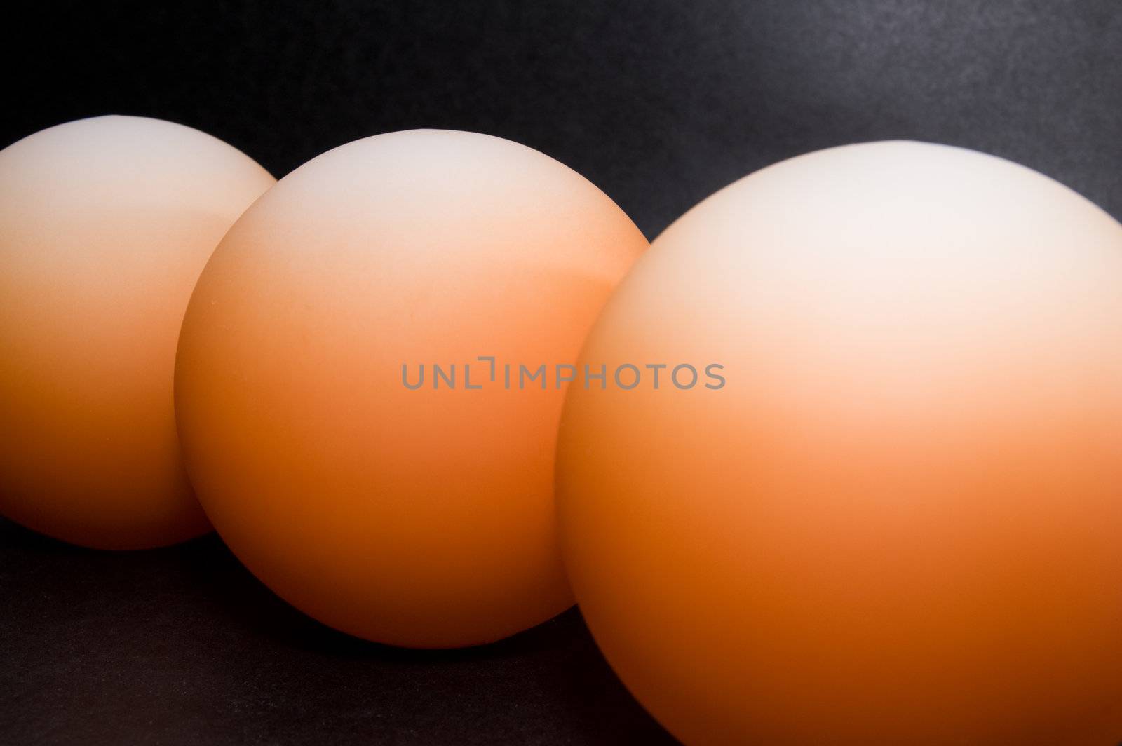 Abstract pattern of orange balls on black background