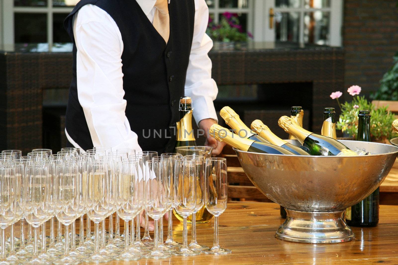 A waiter filled champagne glasses by Farina6000