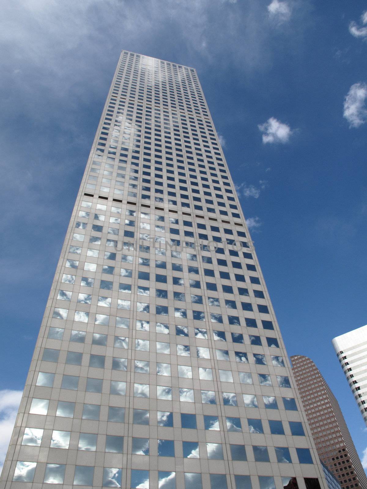Modern Denver office building rises into a bright blue sky