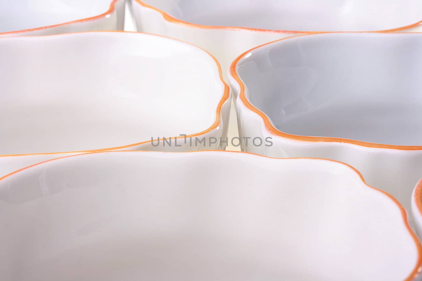 Empty pure cups of white colour with an orange border at restaurant.