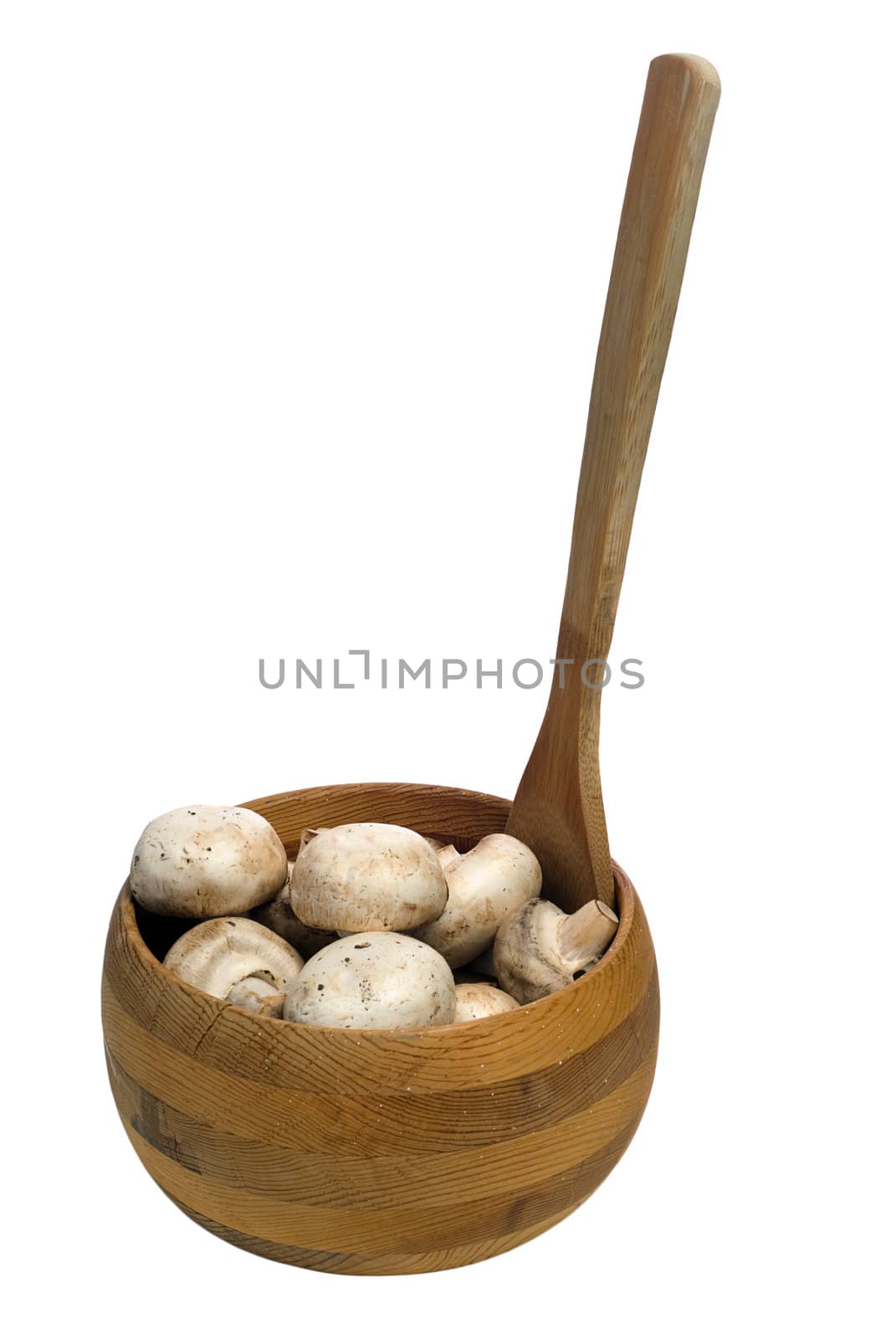 Dirty button mushrooms in a wooden bowl, isolated against a white background