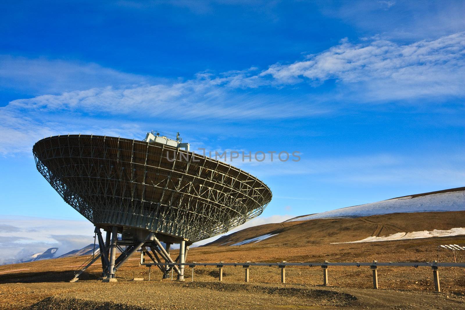 Directional radio antenna on hillside.  Horizontally framed shot.