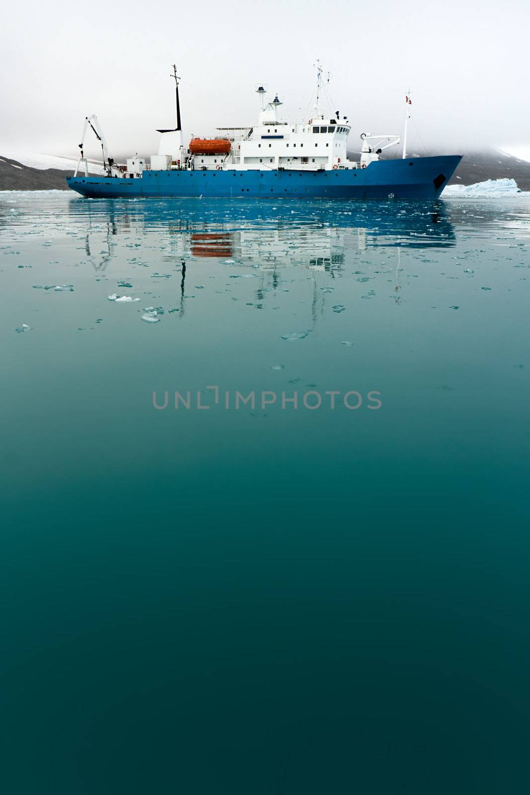 Icebreaker in icy water.  Vertically framed shot.