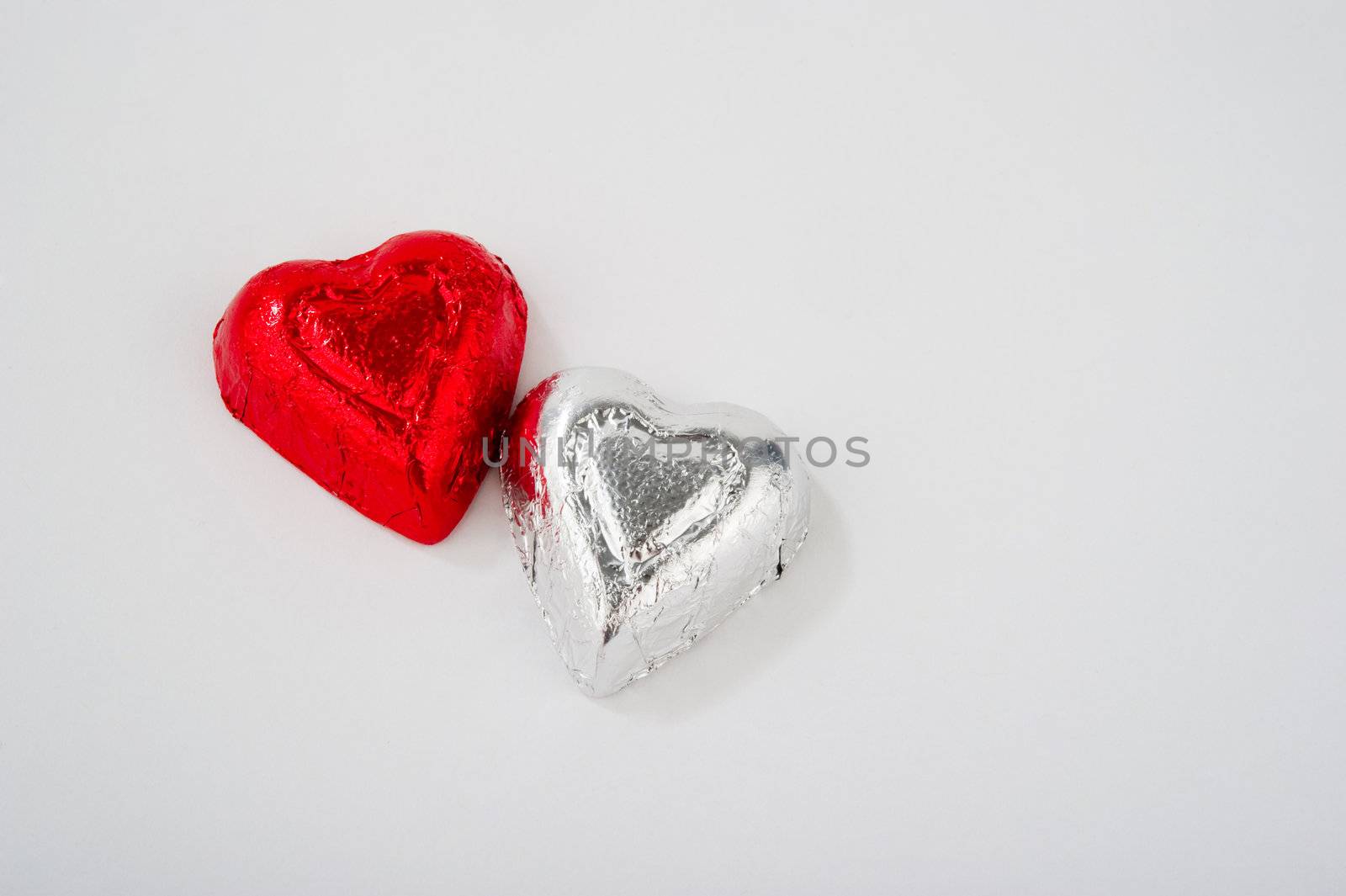 Two Foil Wrapped Heart Shaped Candies by gregory21