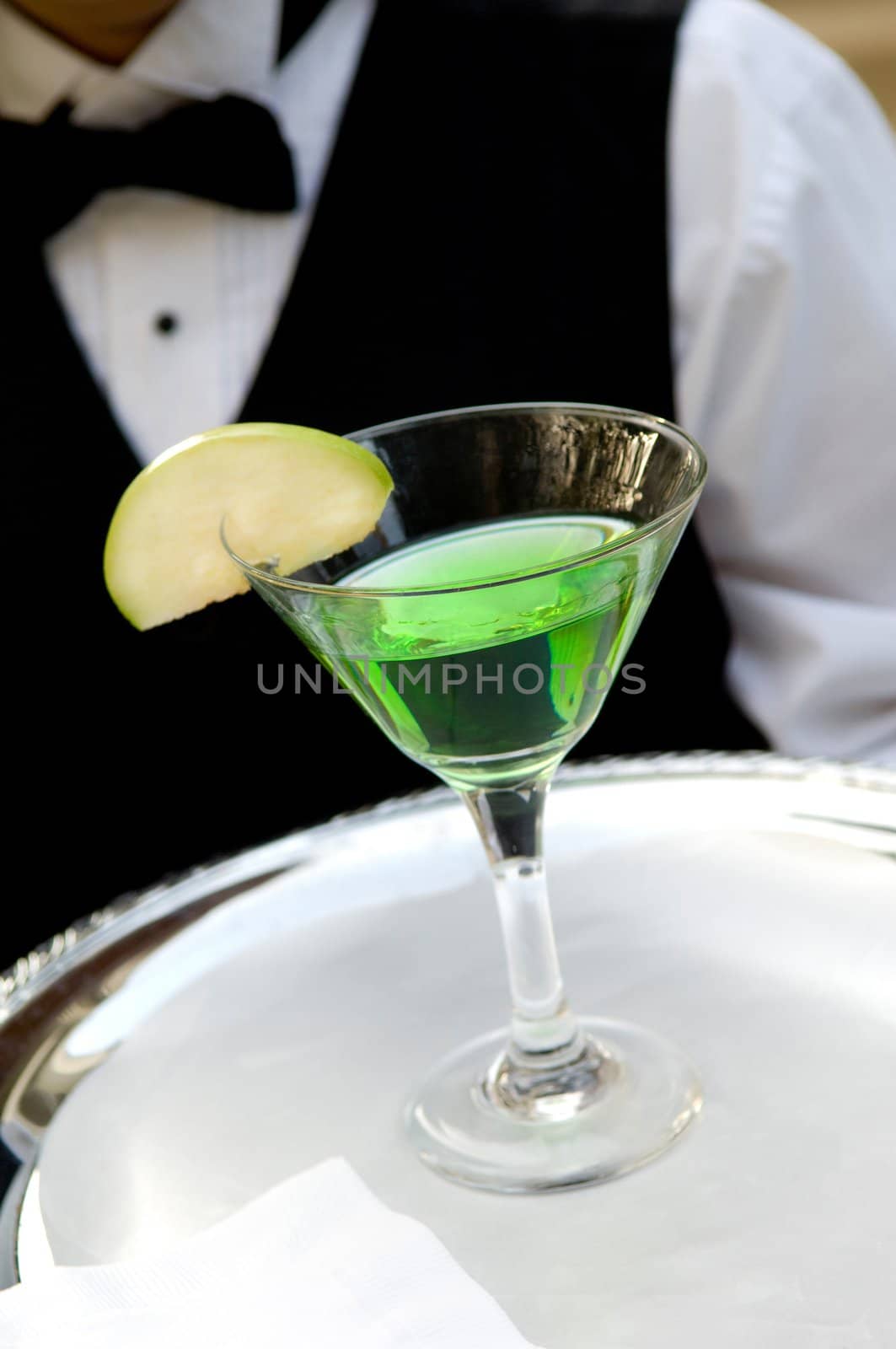 An image of a bright green apple martini