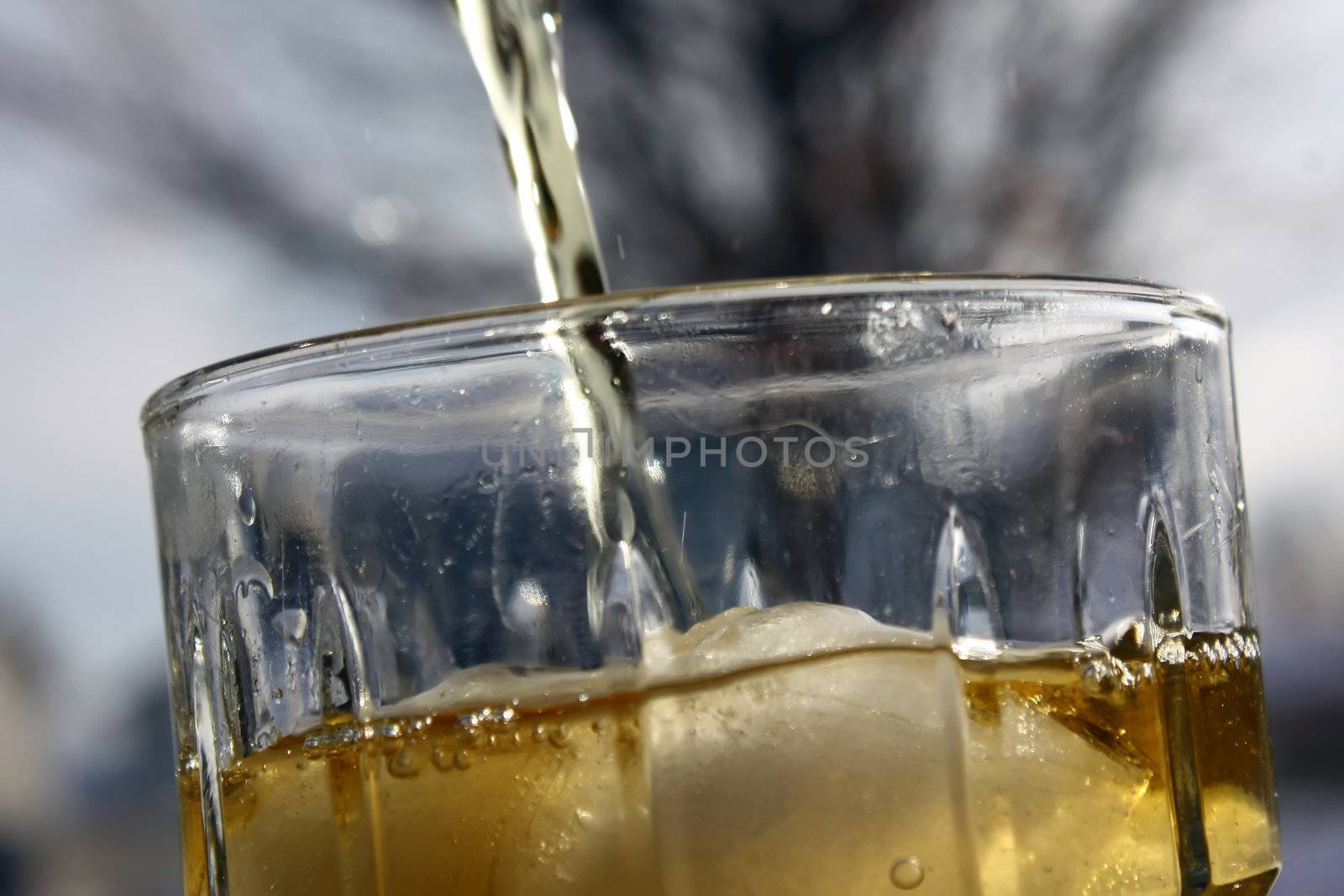 a refreshing glass of iced tea being poured