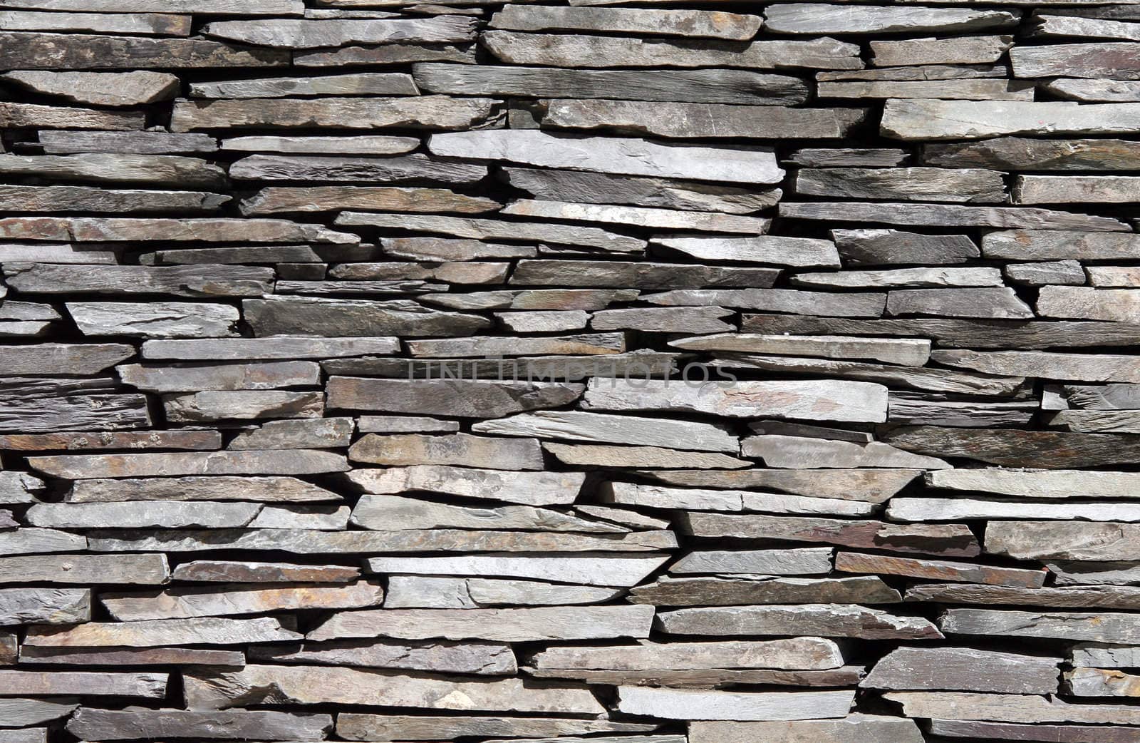 Old Stone Stone Wall Made Of Mant Little Pieces With Different Colours, Textured Background