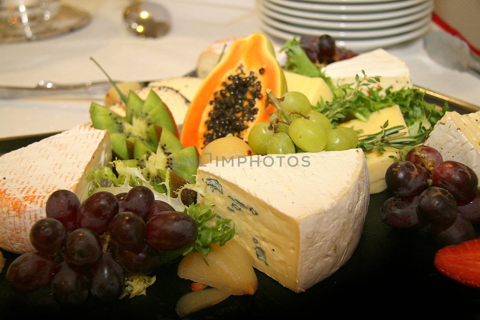 Cheese platter with different types of cheese grapes