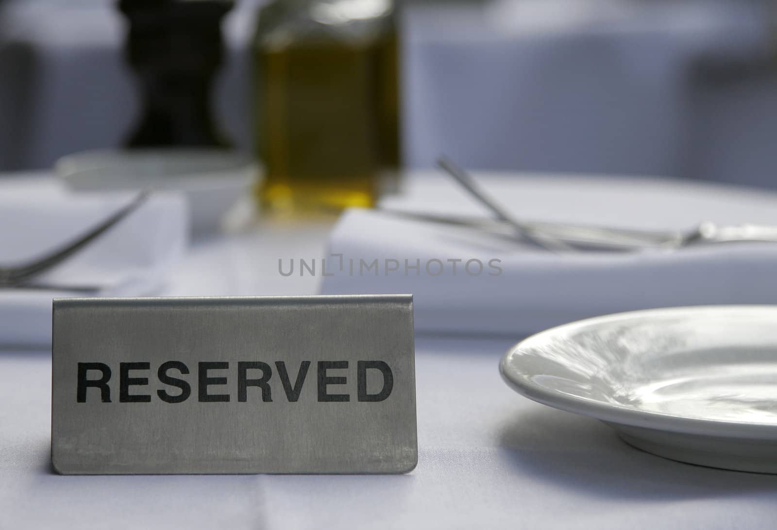 Metallic Silver Reserved Sign On A Restaurant Table