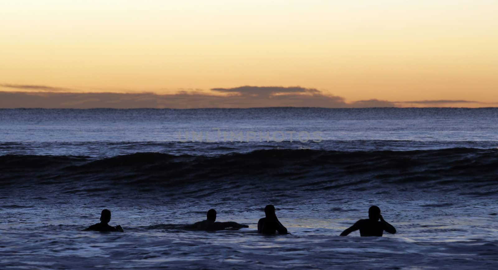 Surfers Paddling Out by thorsten