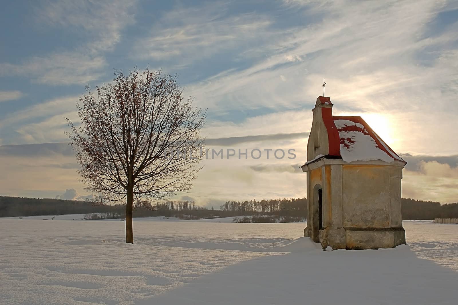 chapel in czech's winter on the snowy field