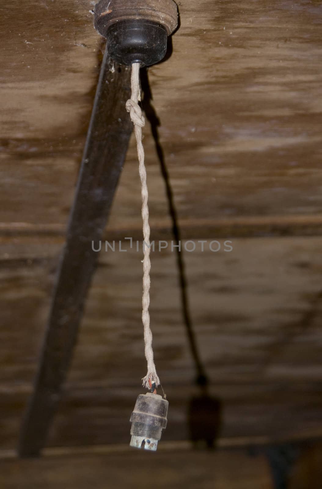 Old lamp cord hangs from the ceiling.