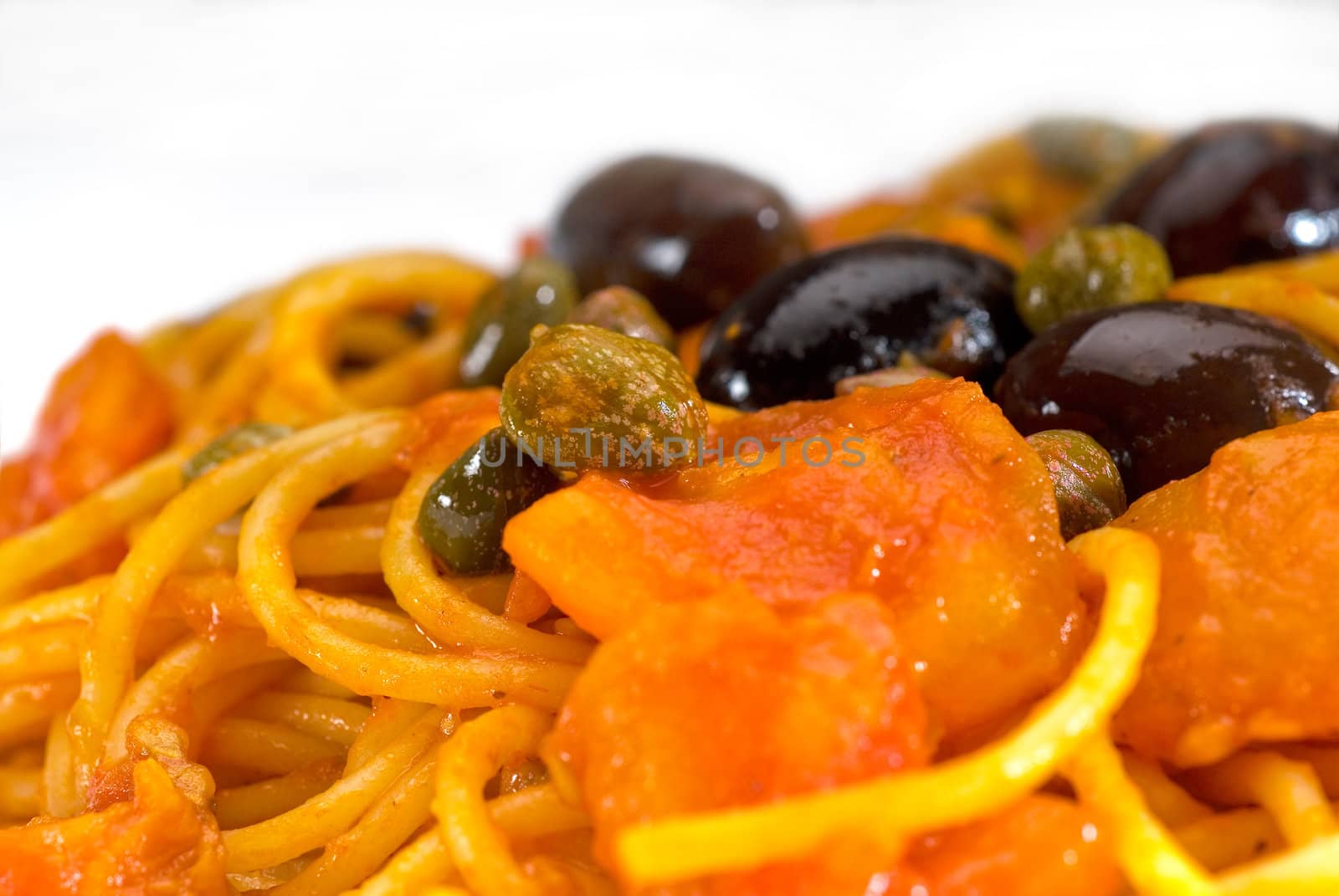 spaghetti italian pasta with fresh home made  puttanesca sauce,extreme closeup,macro