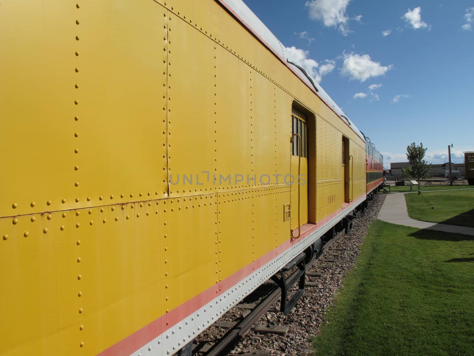 Vintage railroad car rests on tracks in depot