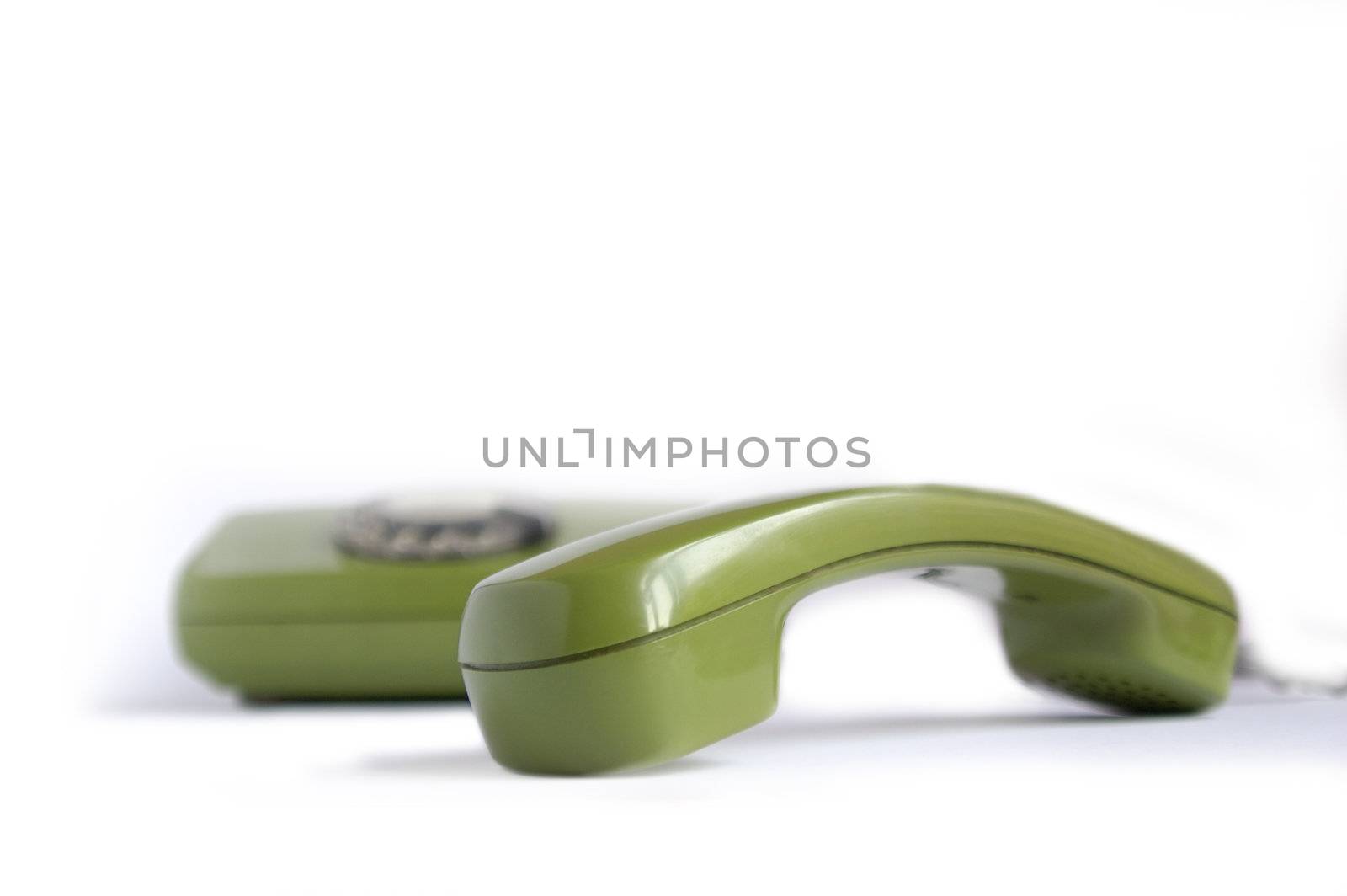 Closeup of green telephone on white