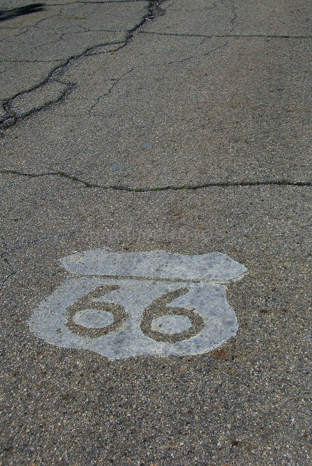 Rt. 66 shield painted on old, decaying highway