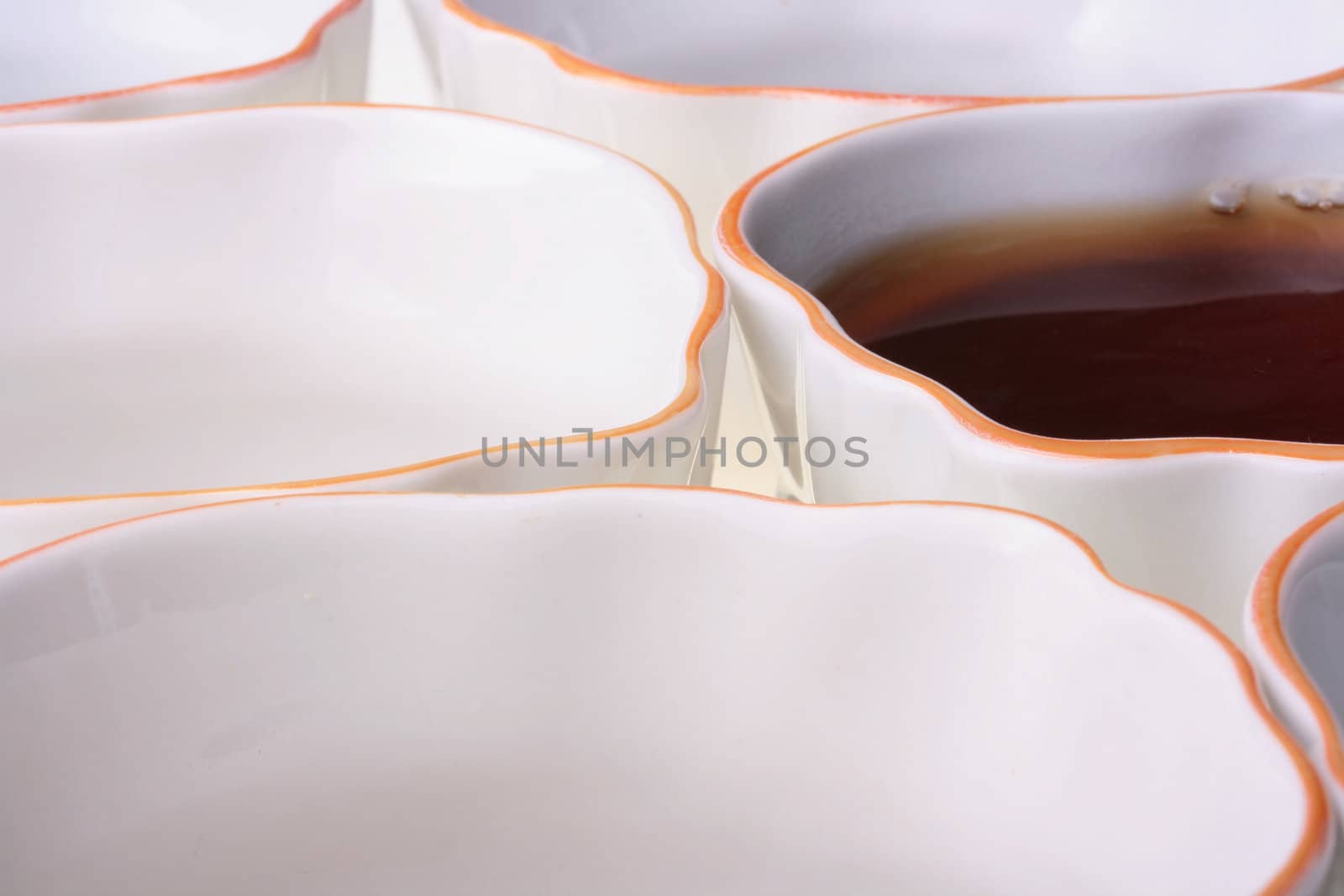 Tea cups in one of cups black tea, a theme of restaurant or cafe.