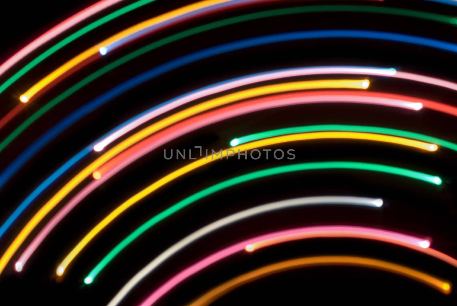 abstract background composed of arcs of blurred coloured light