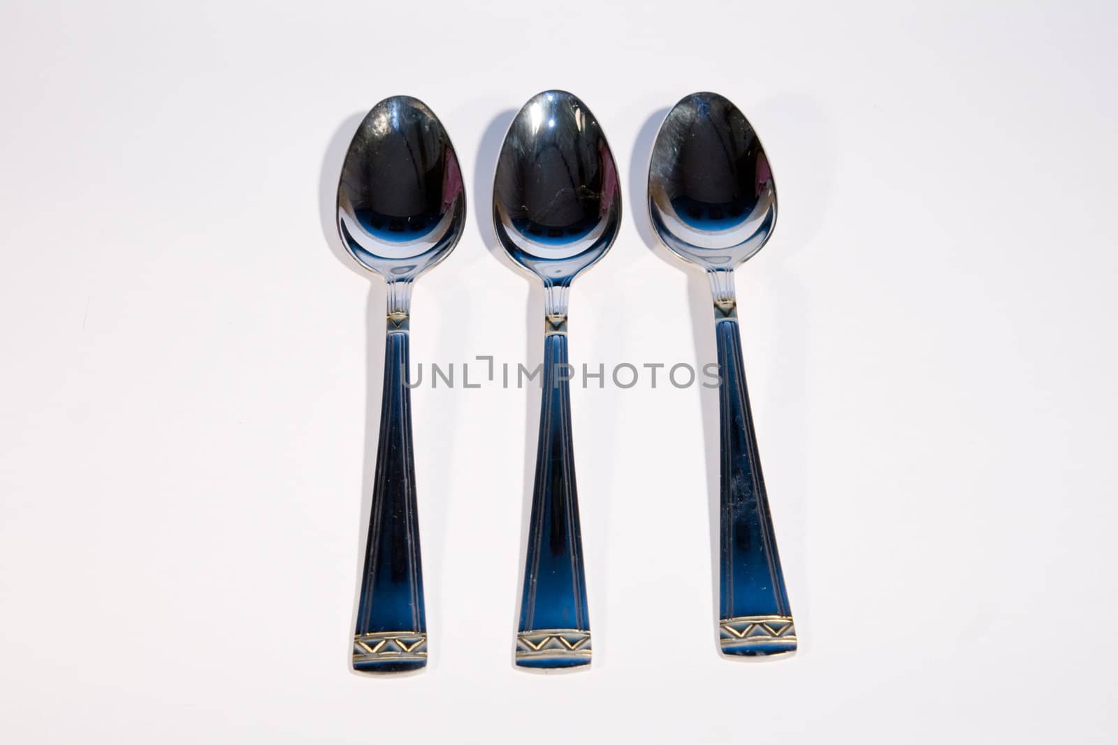 Light metal spoon on a white background