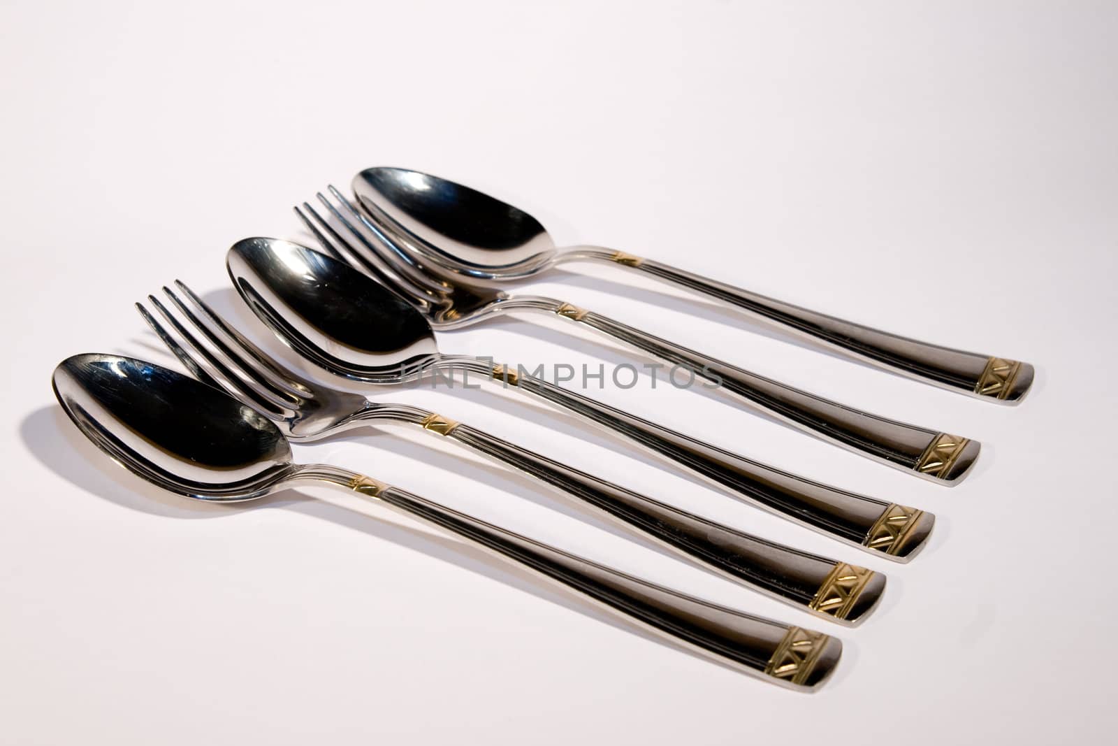 Light metal spoon end plug on a white background