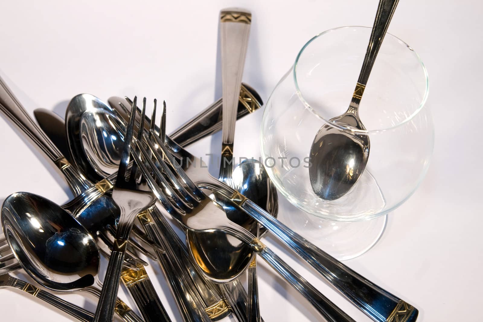 Light metal spoon end plug on a white background