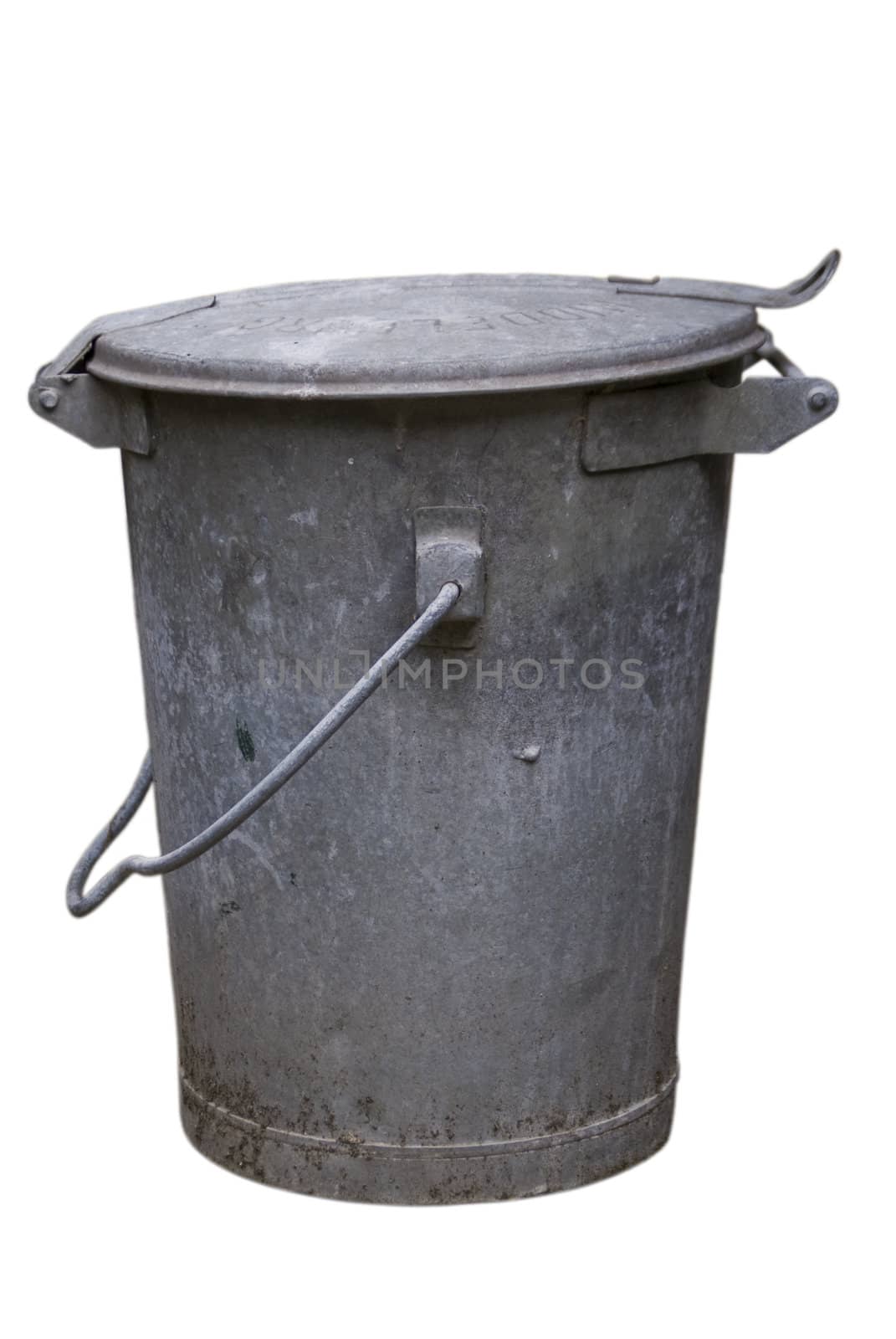 Old authentic heavy metal gray trash can against a white background.
Lid is closed, handle is down to the side. Wear and tear is visible but not dominant, trash can in still in use.