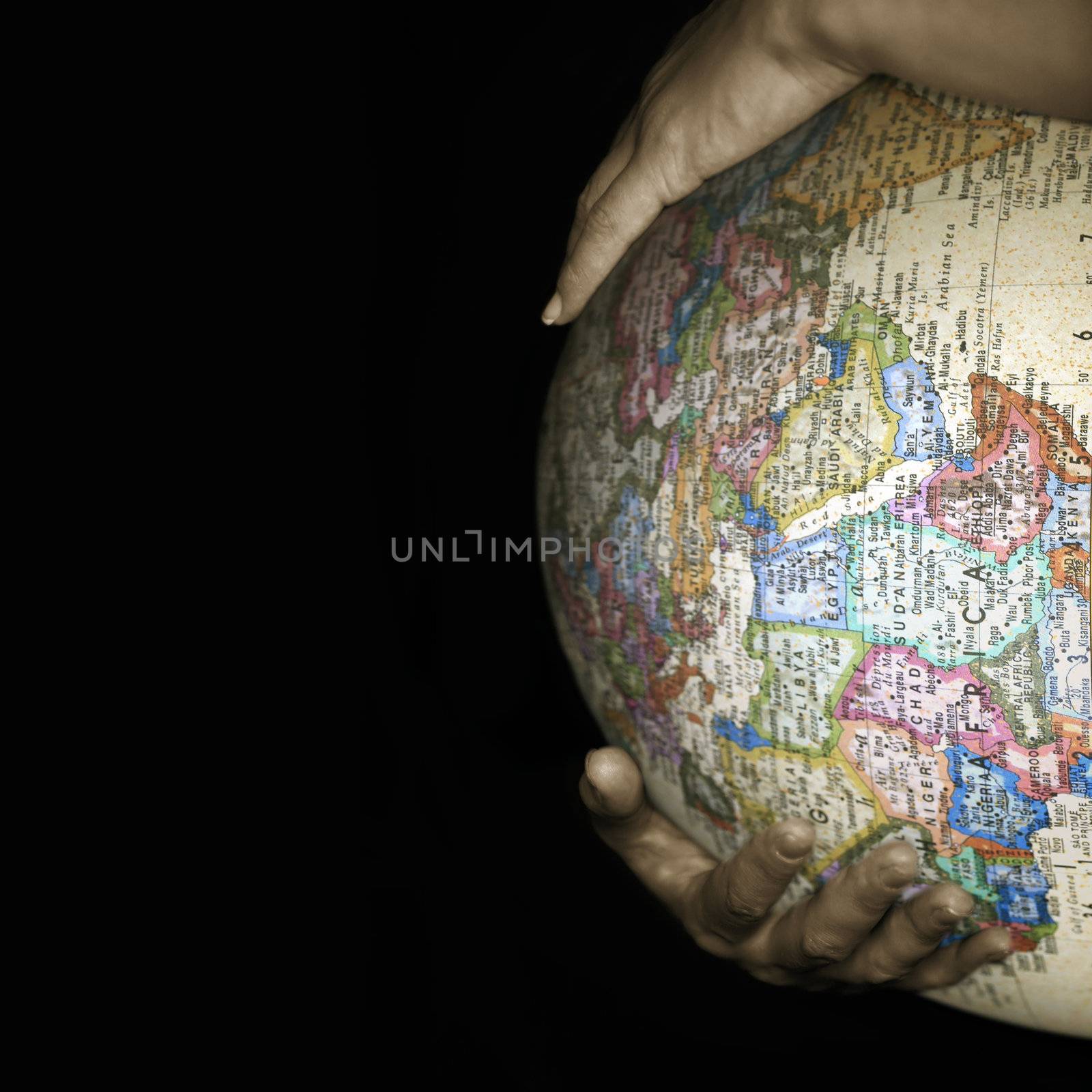 Stomach of the pregnant woman with a texture of a map of the world