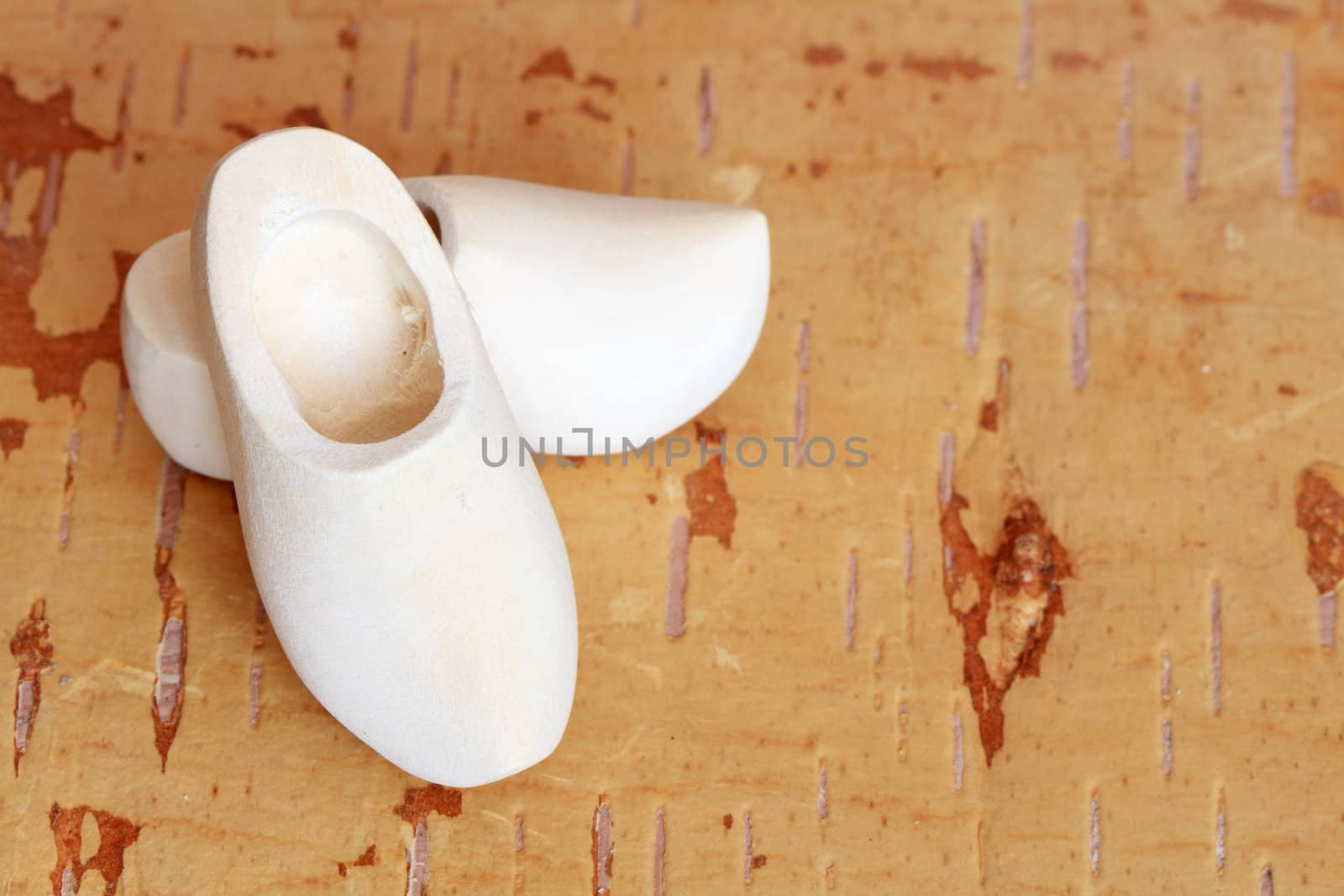 Traditional wooden holland clogs on wooden background with copy space